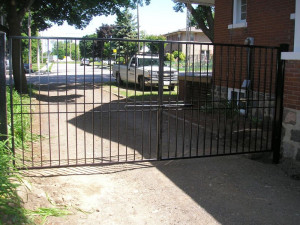 Driveway gate with slide handle